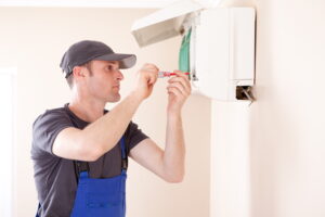 Air conditioner technician servicing indoor.