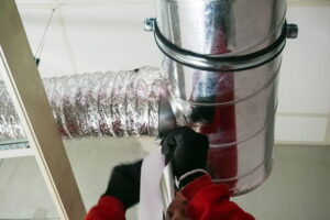 Male hands setting up ventilation system indoors